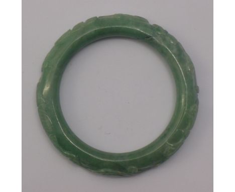 A carved jade bangle
