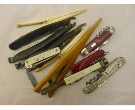 A quantity of vintage penknives, glove stretchers, razors and cigar cutters