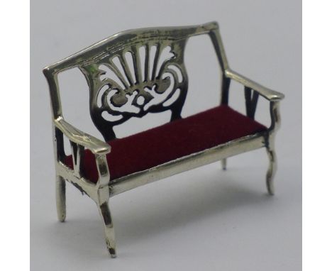 A miniature silver sofa