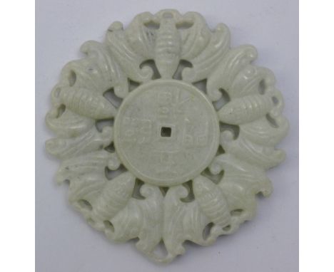 A white jade roundel decorated with bats