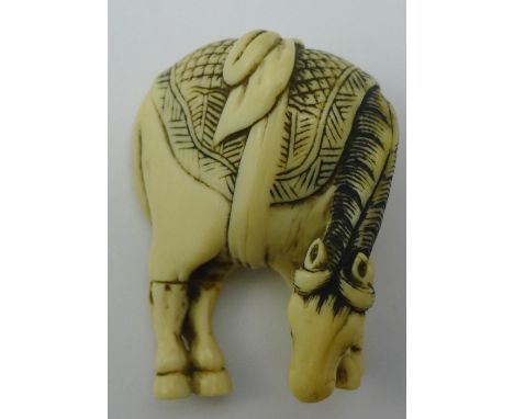 An 18th/19th century carved ivory netsuke formed as a horse