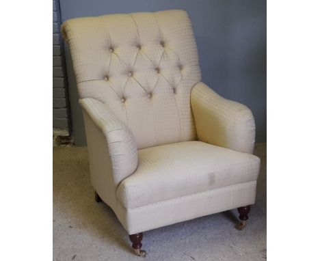 A large upholstered button back armchair