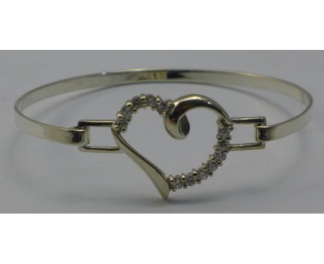A silver heart bangle