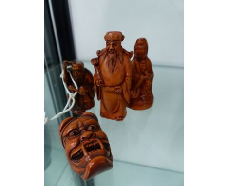 FOUR CARVED WOOD NETSUKE AND OKIMONO.