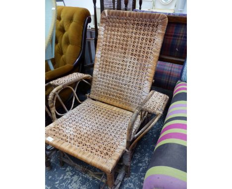 A VINTAGE RATTAN RECLINING GARDEN ARMCHAIR.