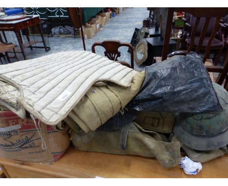 A QUANTITY OF MILITARY WEBBING AND A VINTAGE BULLET PROOF VEST.