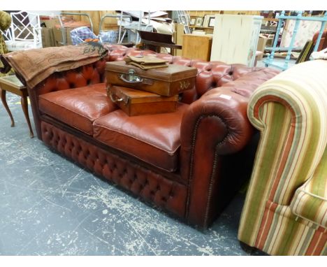 A BUTTON LEATHER UPHOLSTERED TWO SEAT CHESTERFIELD SOFA BED.