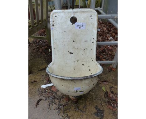 A WALL MOUNTED PAINTED ENAMEL WASH BASIN.