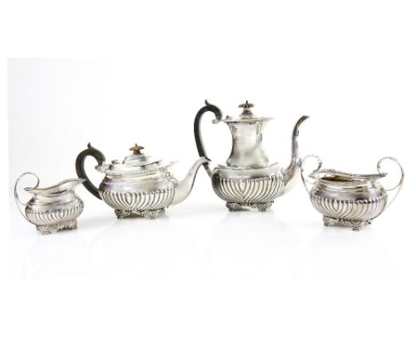 George V silver four piece tea service, comprising tea pot, hot water jug, cream jug and sugar bowl, with half gadrooned bodi