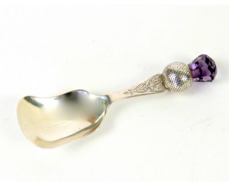 George V silver caddy spoon, with purple glass thistle terminal, by Joseph Cooke &amp; Sons, Birmingham 1925, 10 cm long, 23 
