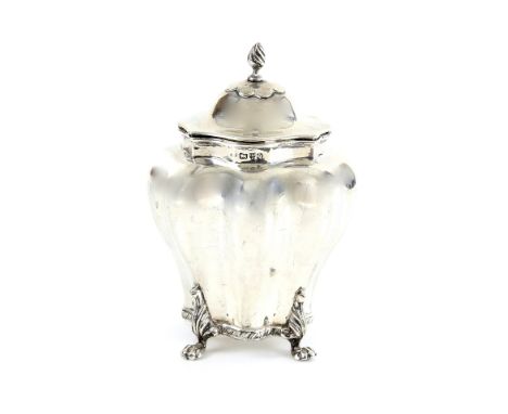 Victorian silver silver tea caddy, the shaped octagonal body on four lion paw feet, the cover with twist finial, Chester 1899