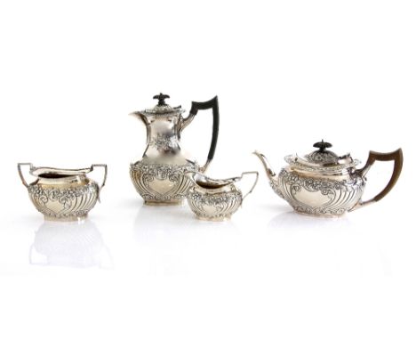 George V silver four piece tea service, comprising tea pot, hot water jug, cream jug and sugar bowl, with embossed decoration