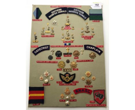 Rhodesian Signals, Chaplains, Army Service Corps 50 items of insignia.  Board with good  display of metal and cloth badges in