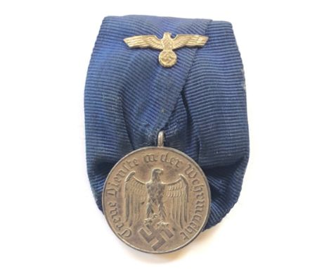 German Third Reich Army 4 year long service medal.  A good silvered example with silver eagle and swastika on ribbon. Mounted