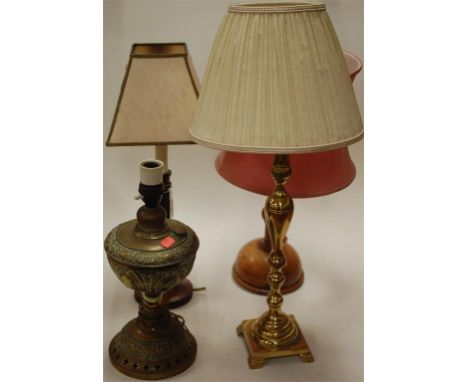 Two brass lamps to include one converted oil lamp and two wooden table lamps (4)