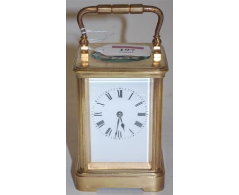An early 20th century lacquered brass carriage clock having white enamel dial and visible platform escapement 