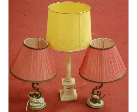 A pair of gilt metal table lamps with pleated silk shades, and one other onyx table lamp (2)
