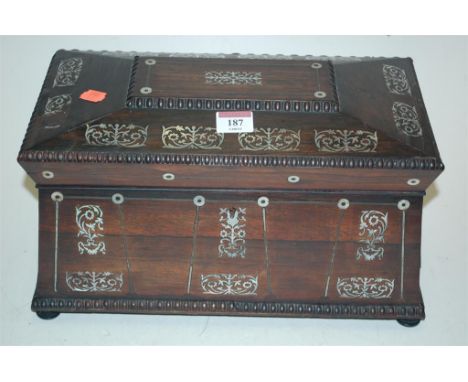 A circa 1830 rosewood and mother-of-pearl inlaid tea caddy of sarcophagus form having fitted interior