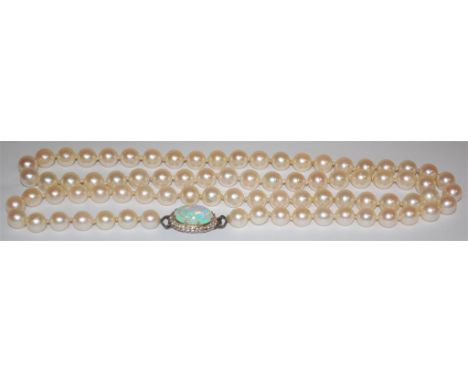 A cultured pearl single string necklace having opal and white sapphire set clasp