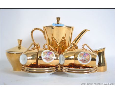 A Bavarian 20th century gilt lustre tea service to include the teapot, cups, plates etc