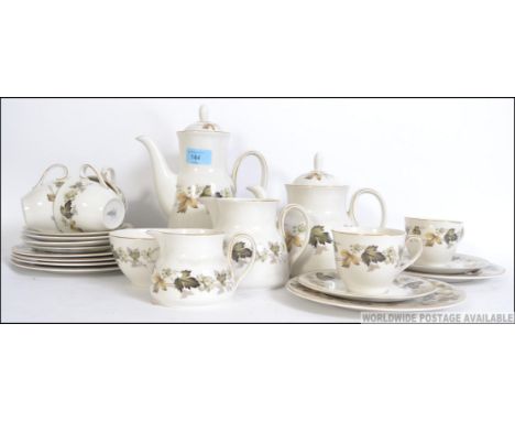 A Royal Doulton Larchmont pattern part tea service in a chintz flower design to include teapot, cups, saucers, plates etc