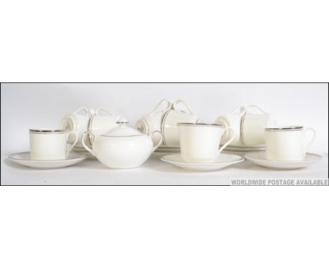 A part Royal Doulton Platinum Concorde pattern tea service. Comprising of 8x cups and saucers, sugar bowl etc.