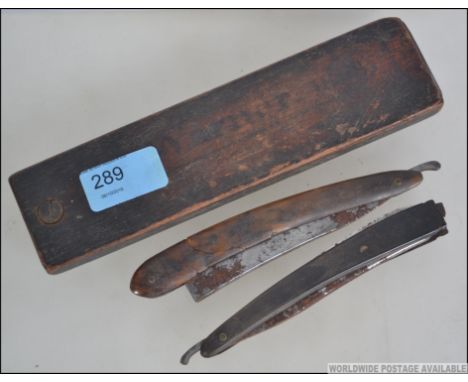 A Victorian tortoiseshell cut throat razor together with another in an early wooden box with swivel top being marked for Morg
