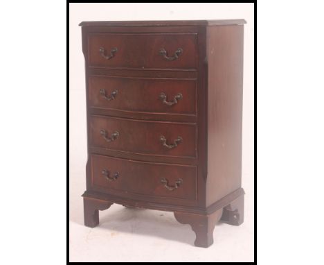 A Georgian style mahogany small bachelors bow front chest of drawers raised on bracket feet with short and deep drawer config