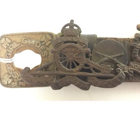 WW2 British cap badges all fixed onto a Girl Guides belt. 15 badges to include RA x 2, North Staffs, The Welch Regt, ATS, RE,