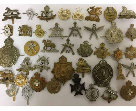 A large collection of over 60 restrike British Army cap badges. WW1, WW2 and some original post war Staybrite pattern badges.