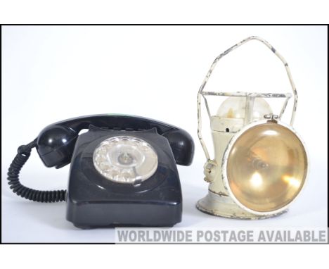 A vintage retro black ring dial telephone together with a vintage railways two way lantern with carry handle. Measures: 26cms
