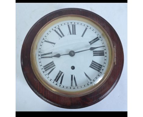 A 20th century stained pine station clock of circular with convex glass and roman numeral chapter ring. Attached key and pend