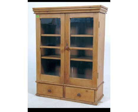 A 19th century pine cabinet cupboard having 2 short drawers under glazed cabinet above with shelf lined interior within. Meas