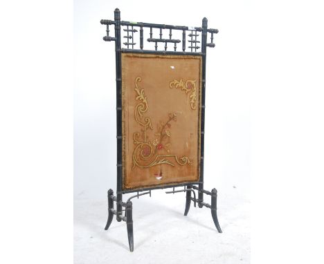 A Victorian Aesthetic movement fire / discretion screen in ebonised bamboo with a central silk embroidery
