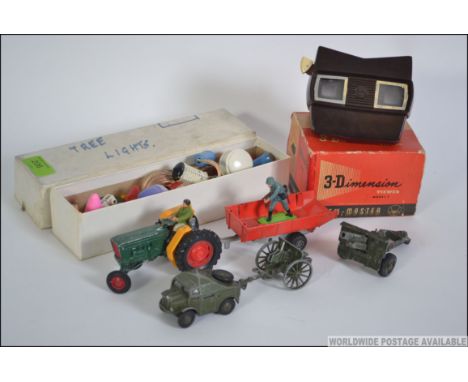 A bakelite viewmaster 3-d viewer together with die cast to include Dinky Field Artillery tractor, Crescent Toy artillery and 