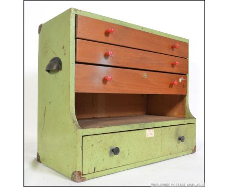 A mid 20th century painted workmans wooden toolbox, having a run of three drawers brass carry handles to the side. Measures: 