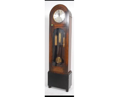 A 1930's Art Deco oak longcase clock having dome top with silvered dial, roman numeral chapter ring. The trunk with glass win