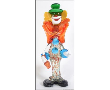 A retro 1960's / 1970's tall Murano clown. Standing 37cm tall with a green hat, blue buttons and matching cuffs with a speckl