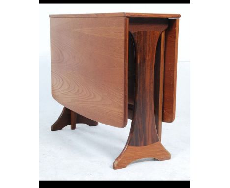 A retro 20th century G-Plan teak drop leaf dining table having splayed foot frame, the end leaves rising on gate legs. Measur
