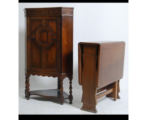 A 1920's Jacobean corner cabinet on stand. Golden oak with central door on turned legs together with an Art Deco style oak ga