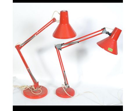 A 20th century HCF Denmark red anglepoise desk lamp with circular base and two tone pendant shade. Together with another simi