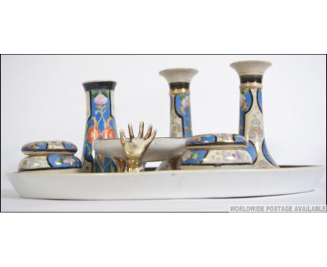 An early 20th century Art Deco Noritake dressing table set of oval tray, pair of candle sticks, hat pin holder, pin dish, rin