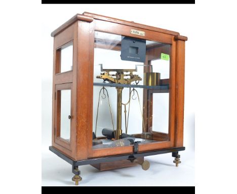 OERTLING   Oak and glass cased brass scales with weights. Measures: 50cms high.