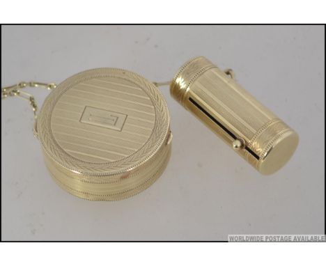 A vintage Houbigant of France Art Deco gilt metal Powder Compact and telescopic lipstick holder united by chain. Both with en