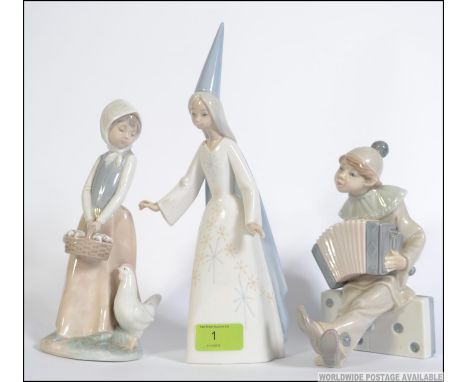 A collection of Lladro ceramic figurines to include Boy Clown with Concertina on Dominoes, Lladro girl good  fairy watch and 