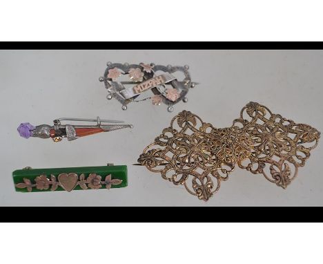 A 9ct gold and jade brooch with forget me not gold on a bar of jade with pin verso together with a silver dirk brooch and a s