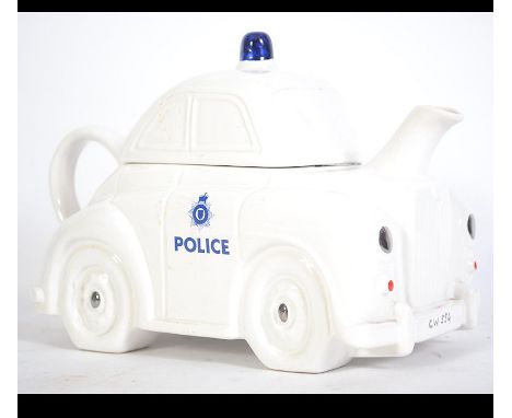 An unusual large 20th century teapot police car stamped to the underside for Carlton Ware. Complete with lid. Measures: 17cms