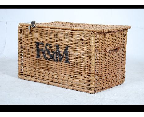 A stunning 20th century large whicker basket come laundry basket with lid attached by leather straps having F & M printed not