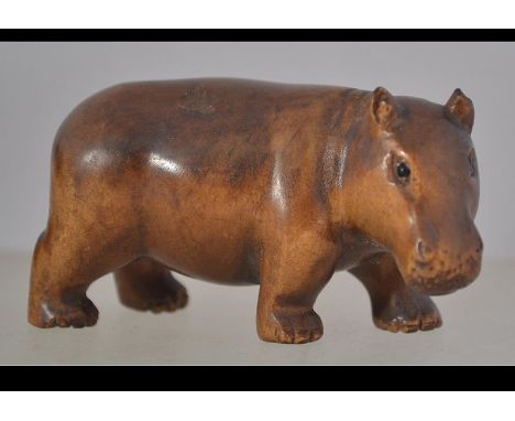 A well carved wooden Japanese netsuke in the form of a hippo,pierced holes to the rear
