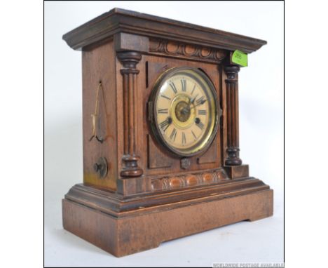 An Edwardian oak cased " Bugler " alarm mantel clock labelled to verso Thomas Fattorinis with original notation to interior a